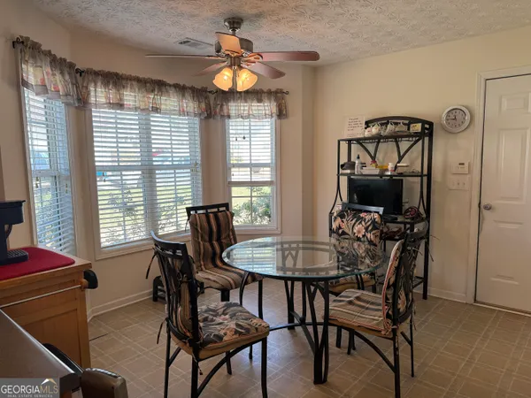 a view of a dining room with furniture and a window
