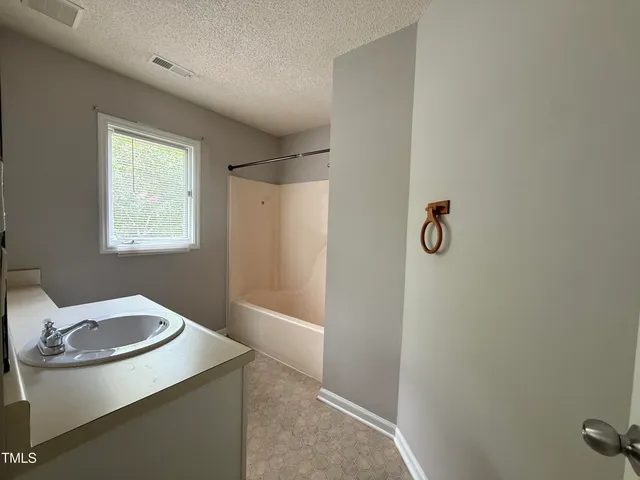a bathroom with a sink and mirror