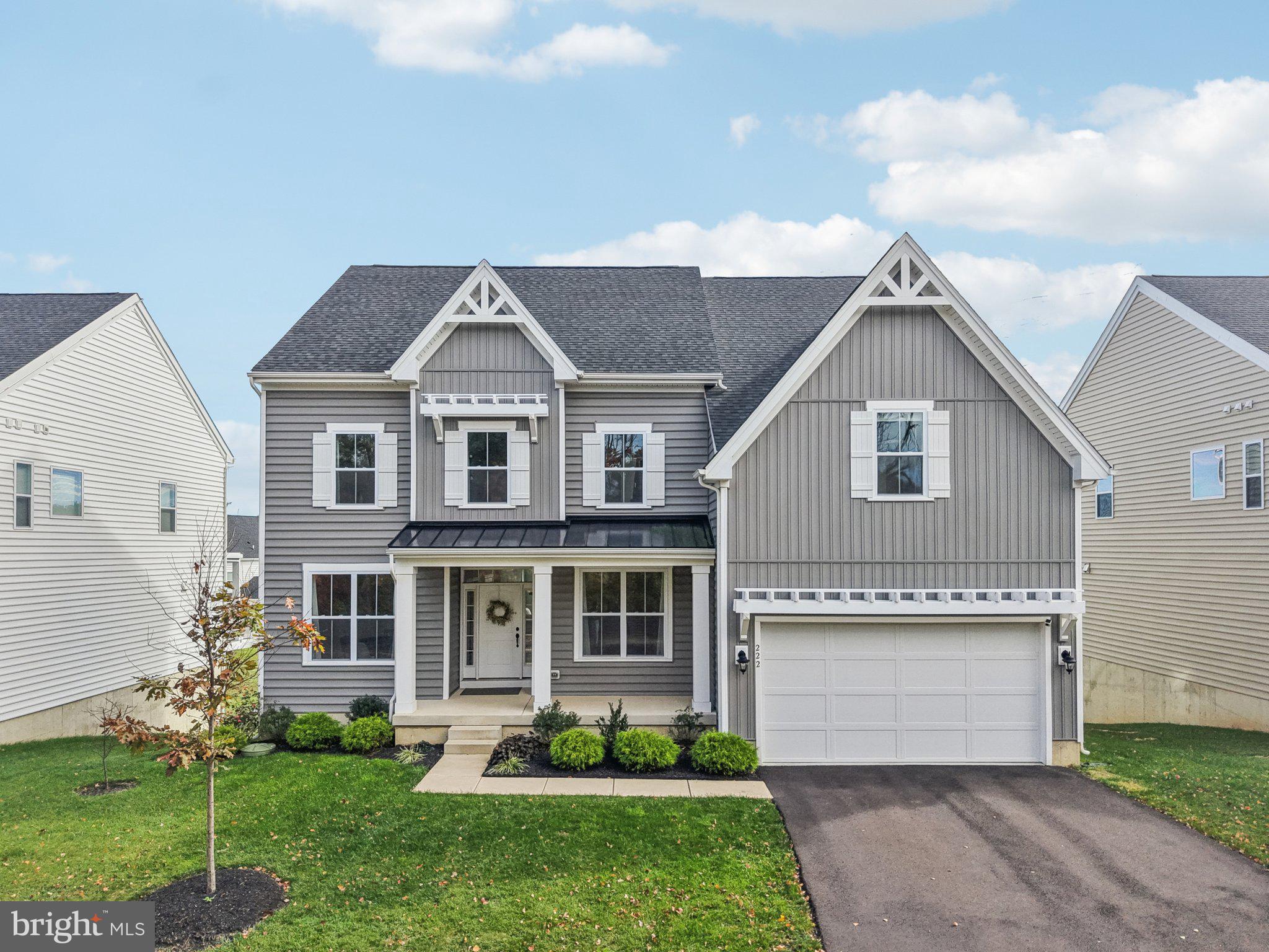 a front view of a house with a garden and plants