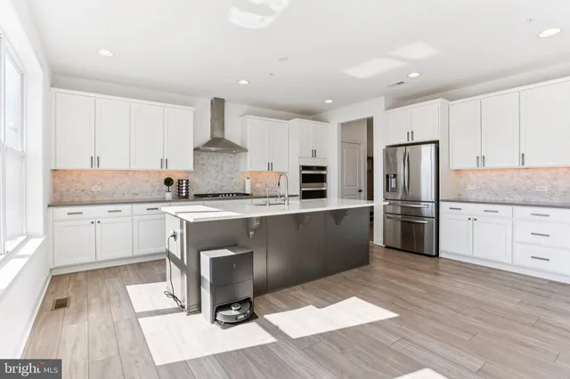 a kitchen with a sink stove and refrigerator