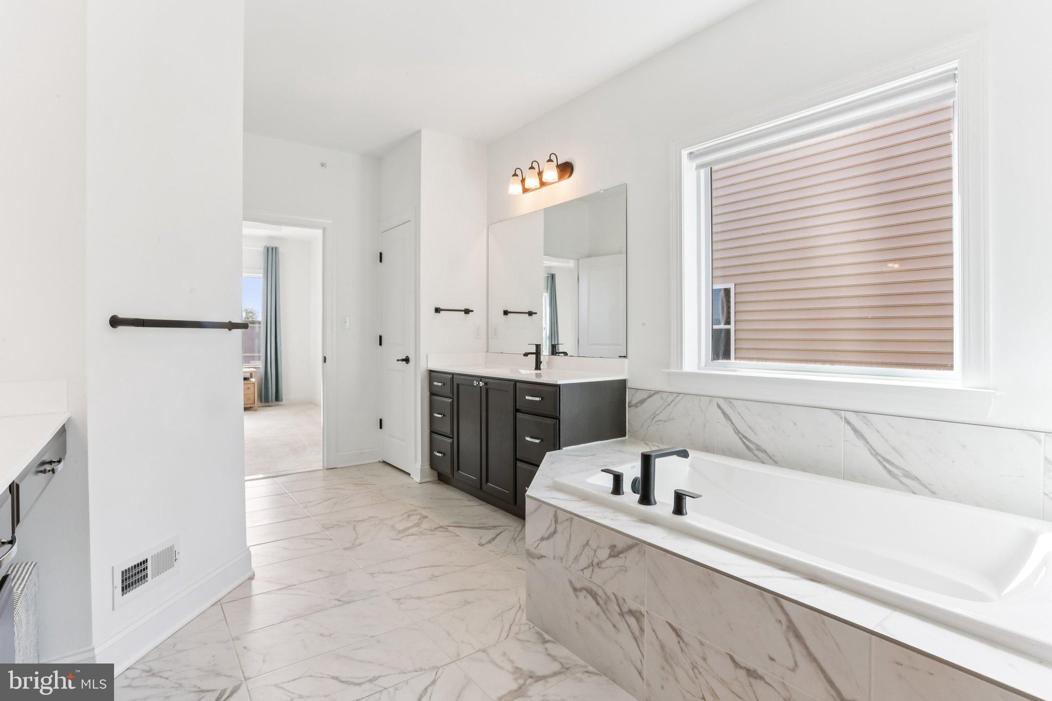 222 Grv Vly Court Chalfont, PA 18914 - Photo 26 of 46 a large white tub sitting in a bathroom next to a window