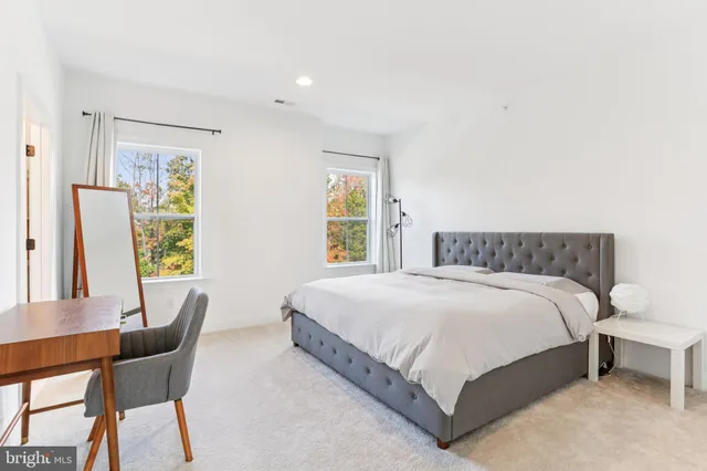 a large white bed in a white room