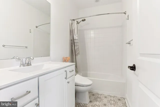 a large bed sitting in a bedroom next to a window