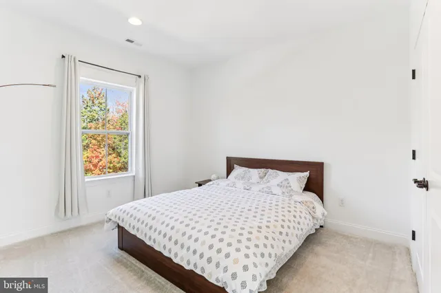 a large bed sitting in a bedroom next to a bathroom