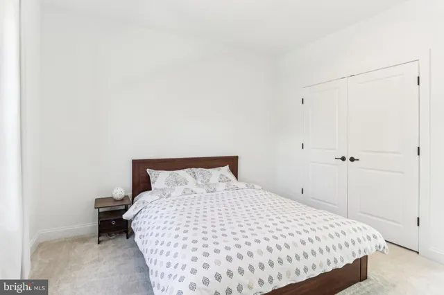 a bathroom with a granite countertop sink a toilet and a mirror