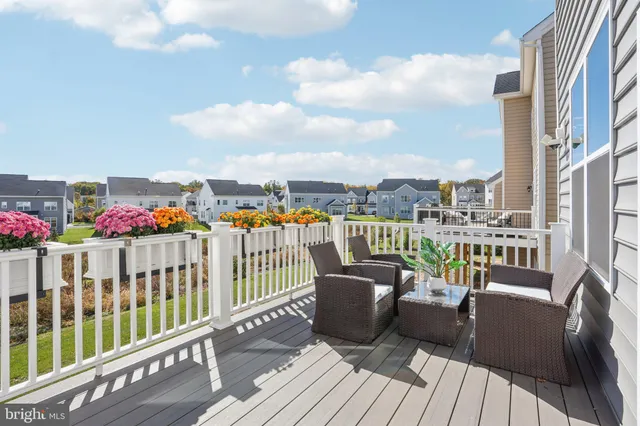 a balcony with furniture and a potted plant