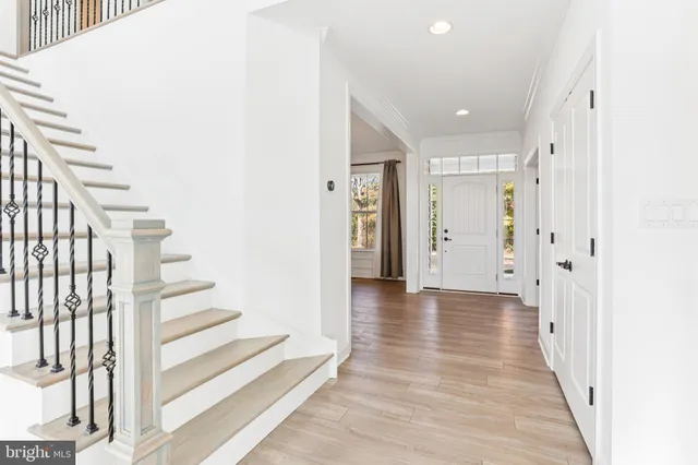 a view of a kitchen area with furniture and wooden floor