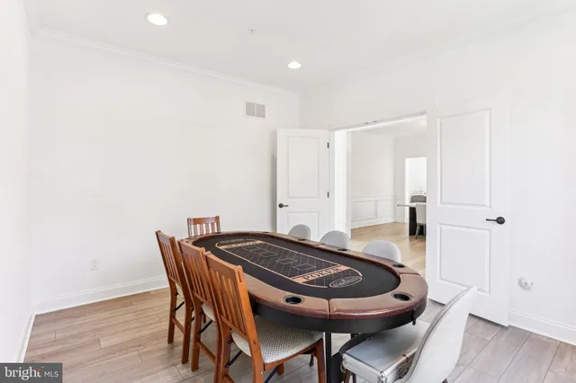 a dining room with furniture and wooden floor