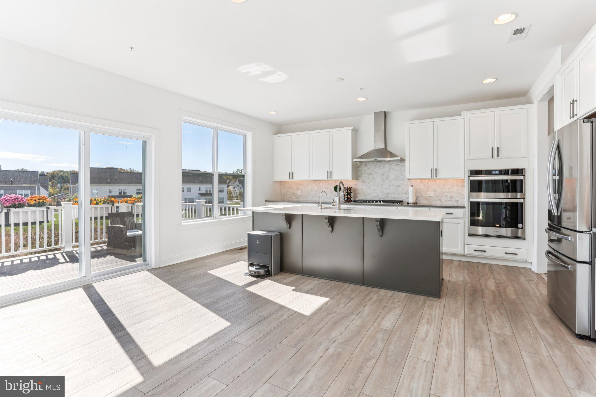 222 Grv Vly Court Chalfont, PA 18914 - Photo 10 of 46 a kitchen with stainless steel appliances kitchen island granite countertop a refrigerator a stove a sink and white cabinets with wooden floor