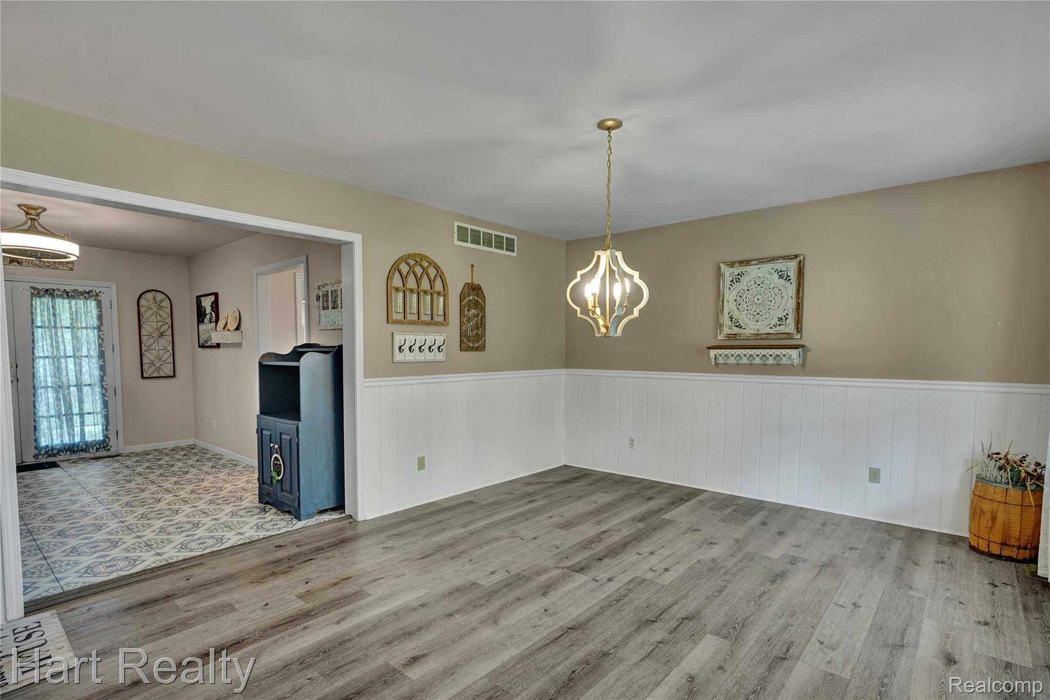 7167 Brown School Road North Branch, MI 48461 - Photo 10 of 51 Open interior space featuring wood-finish flooring and a decorative chandelier