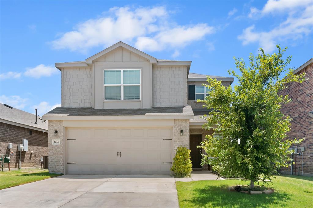 7016 Calshot Road Pilot Point, TX 76258 - Photo 2 of 28 Two-story residence featuring a two-car garage, stone and shingle siding accents.