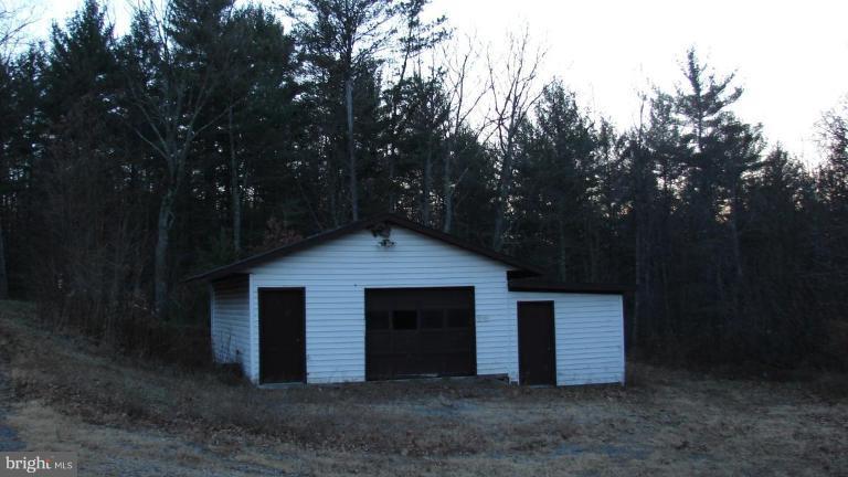 91 Ball Run Road Great Cacapon, WV 25422 - Photo 1 of 26 a view of a house with large trees and yard