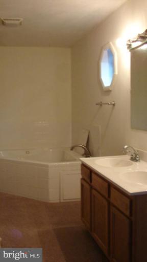 91 Ball Run Road Great Cacapon, WV 25422 - Photo 12 of 26 a bathroom with a sink and a mirror