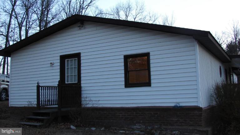 91 Ball Run Road Great Cacapon, WV 25422 - Photo 3 of 26 a view of a house with a yard