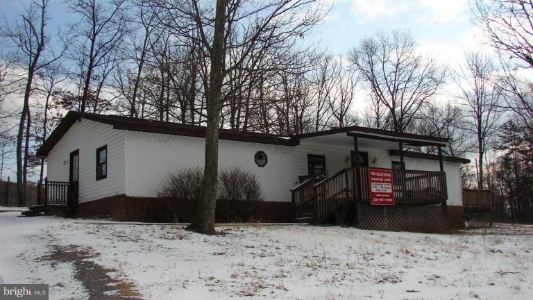 91 Ball Run Road Great Cacapon, WV 25422 - Photo 26 of 26 a view of a house with a snow in the yard