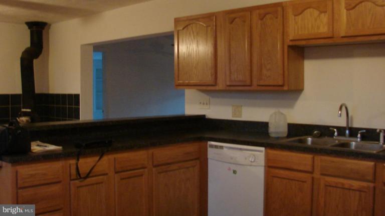 91 Ball Run Road Great Cacapon, WV 25422 - Photo 8 of 26 a kitchen with granite countertop cabinets and a sink