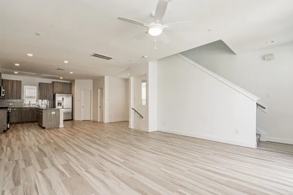 a kitchen with stainless steel appliances granite countertop a refrigerator stove top oven and sink
