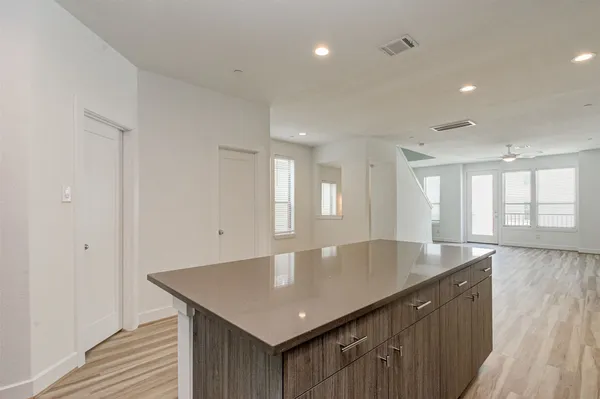 a kitchen with granite countertop white cabinets and black stainless steel appliances