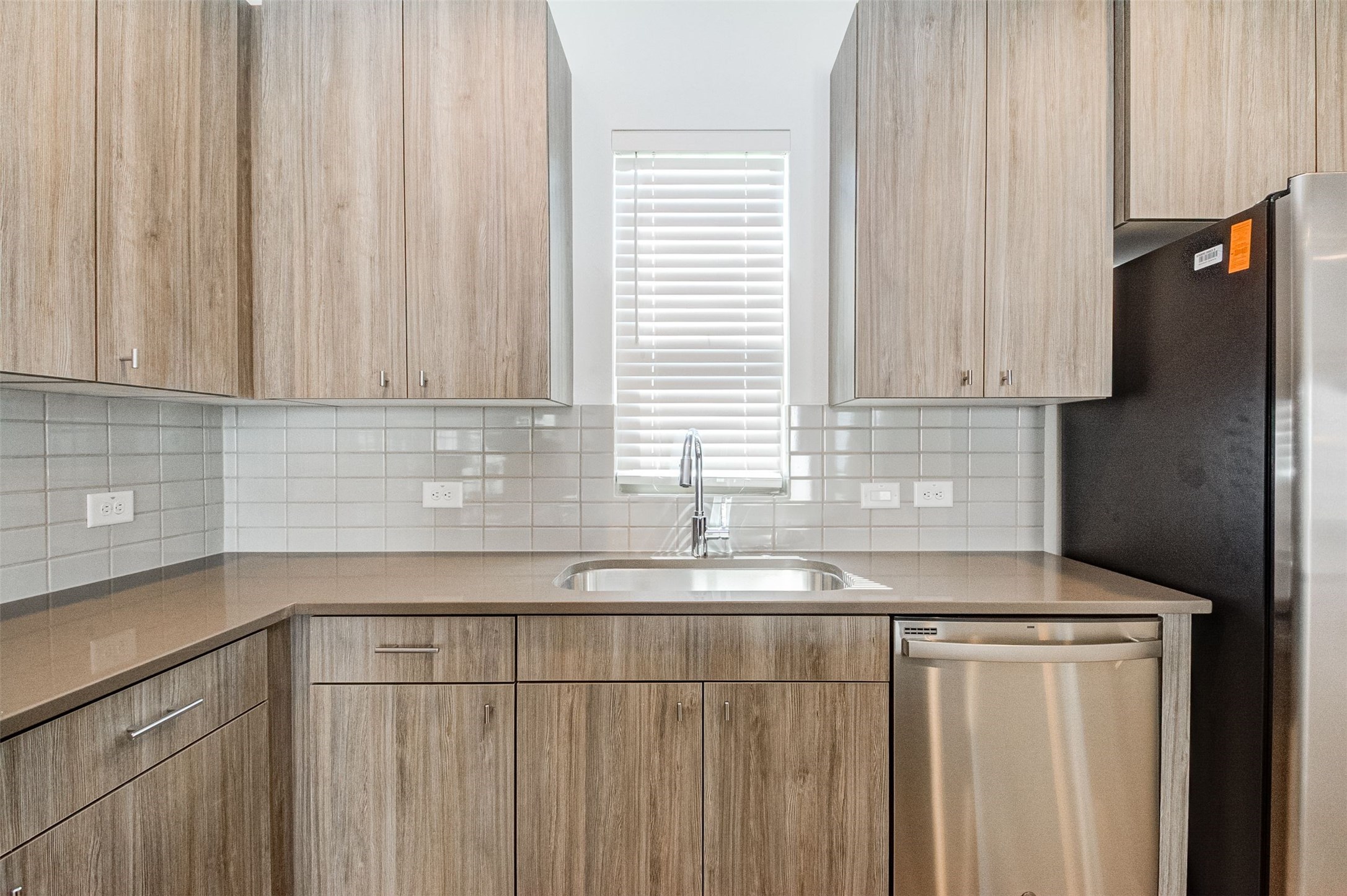 482 South Centro Circle Conroe, TX 77385 - Photo 6 of 23 a kitchen with granite countertop white cabinets and black stainless steel appliances