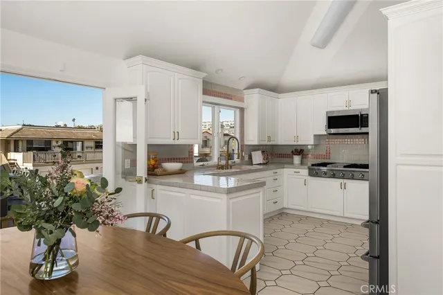 a living room with furniture fireplace and a large window