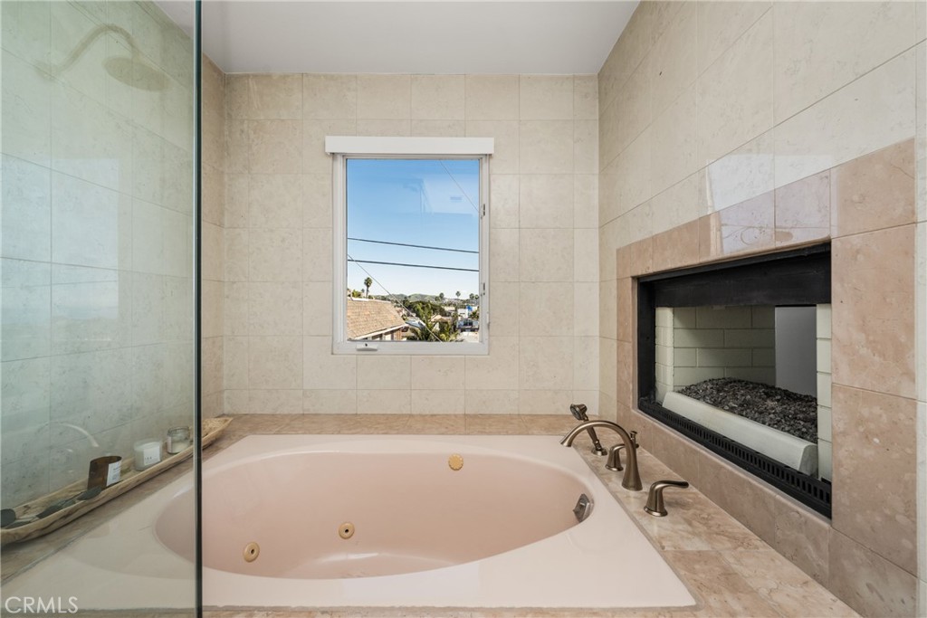 33812 Castano Drive Dana Point, CA 92629 - Photo 22 of 41 Primary double-sided fireplace in bedroom and bathroom.