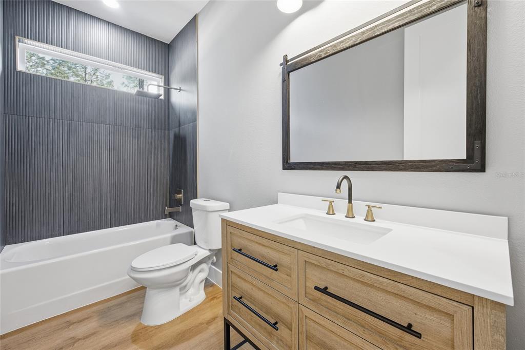 13186 Southwest 52nd Lane Road Ocala, FL 34481 - Photo 17 of 37 a bathroom with a sink a toilet and shower