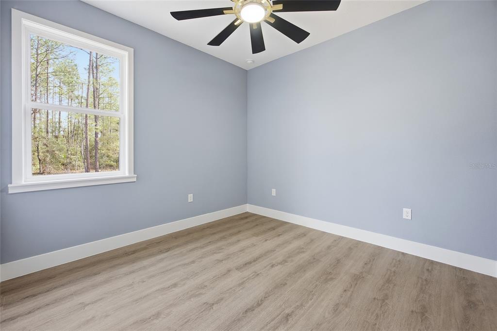13186 Southwest 52nd Lane Road Ocala, FL 34481 - Photo 18 of 37 wooden floor in an empty room with a window