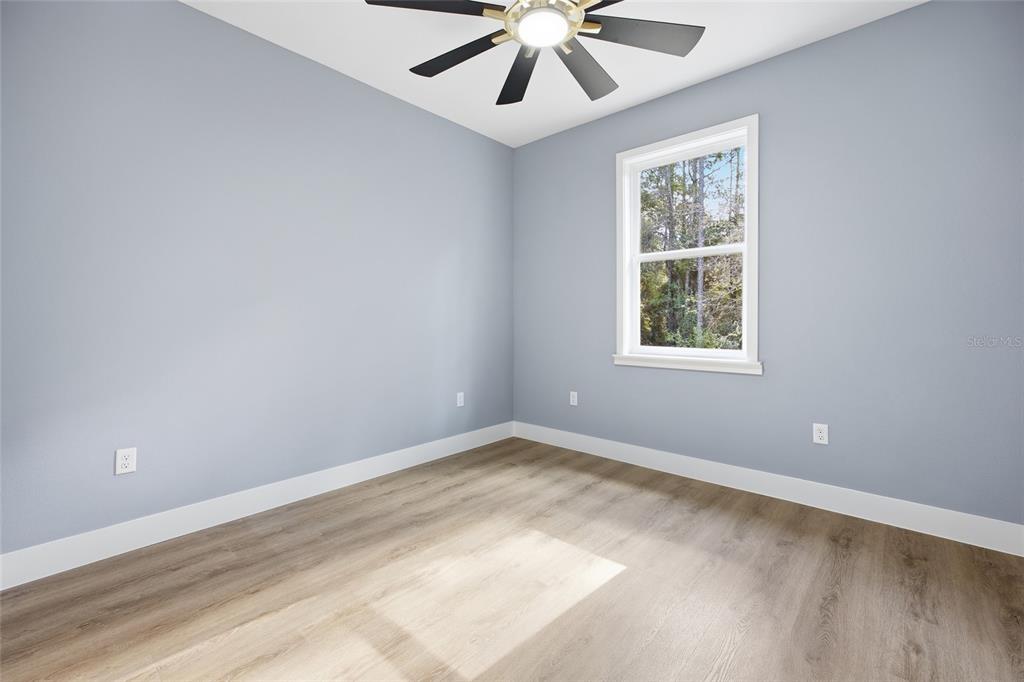 13186 Southwest 52nd Lane Road Ocala, FL 34481 - Photo 20 of 37 an empty room with windows and ceiling fan
