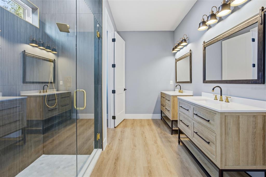 13186 Southwest 52nd Lane Road Ocala, FL 34481 - Photo 25 of 37 a spacious bathroom with a double vanity sink a mirror and shower