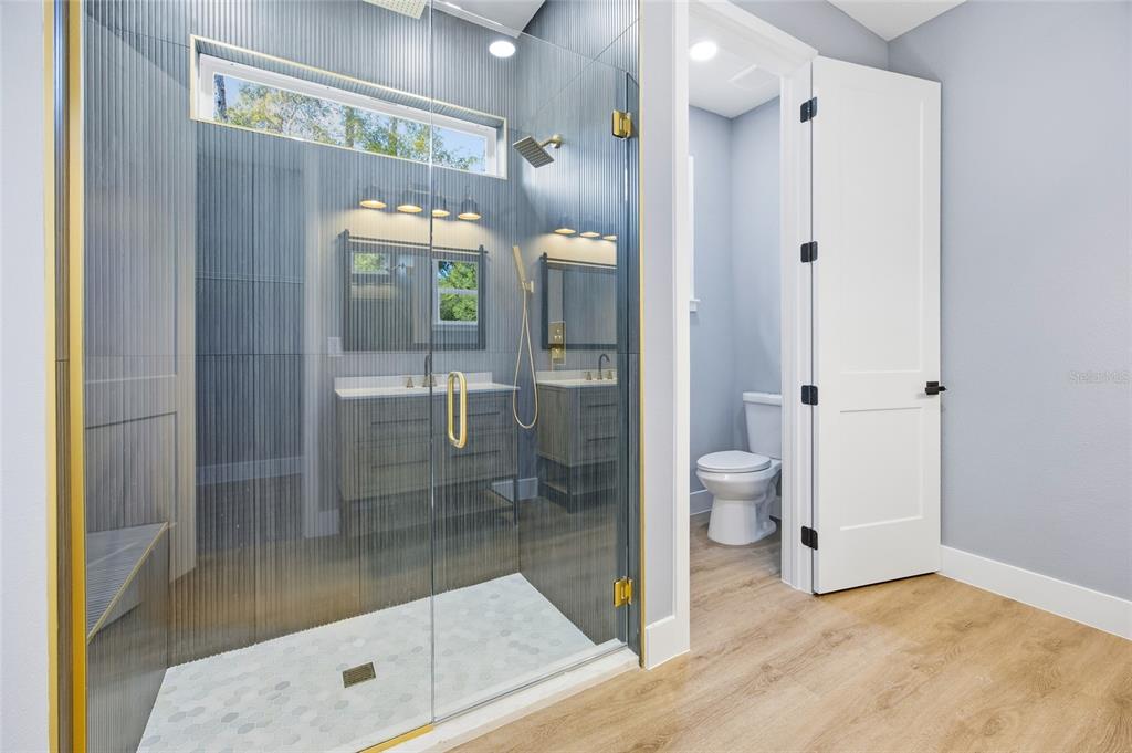 13186 Southwest 52nd Lane Road Ocala, FL 34481 - Photo 26 of 37 a bathroom with a glass shower door and a toilet