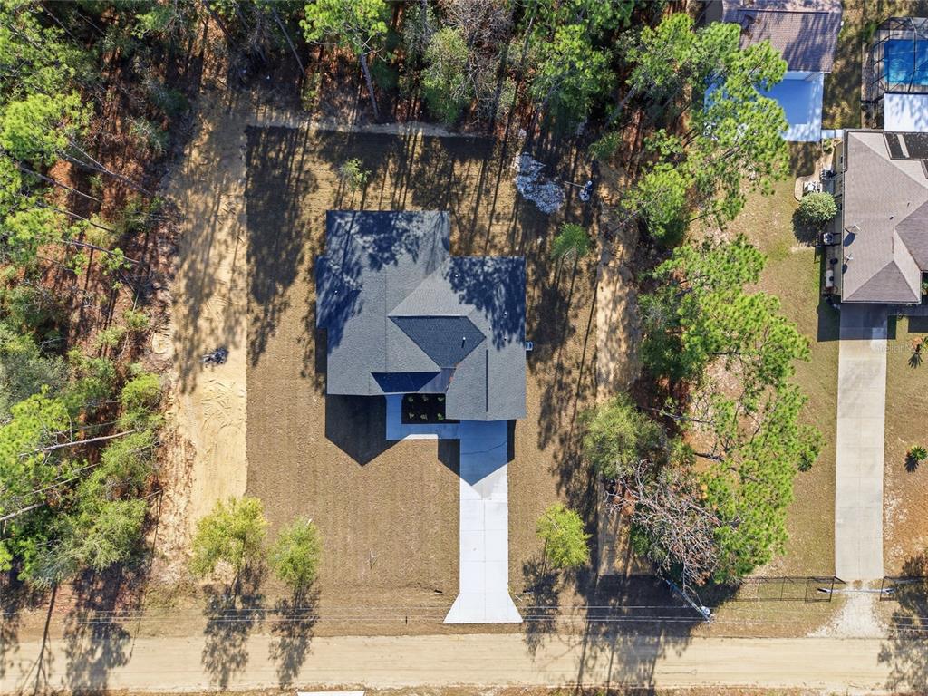 13186 Southwest 52nd Lane Road Ocala, FL 34481 - Photo 36 of 37 a front view of a house with a yard and fountain