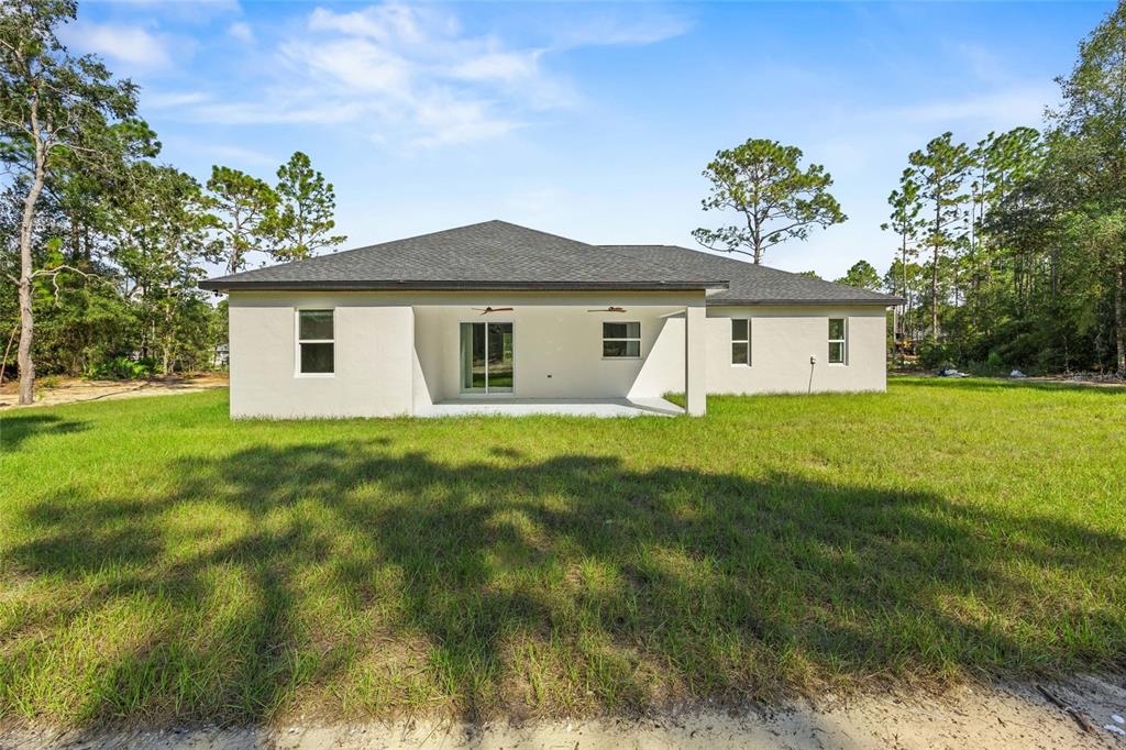 13186 Southwest 52nd Lane Road Ocala, FL 34481 - Photo 5 of 37 a view of a house with a yard