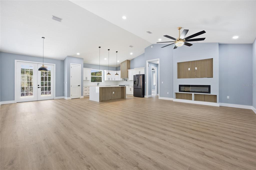 13186 Southwest 52nd Lane Road Ocala, FL 34481 - Photo 8 of 37 a view of an empty room with a kitchen
