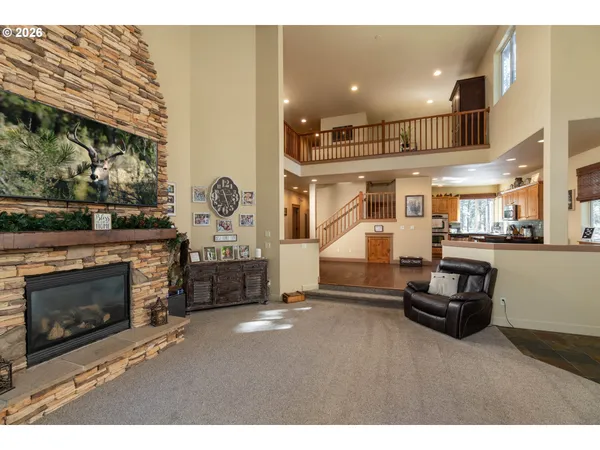 a living room with furniture a fireplace and a window