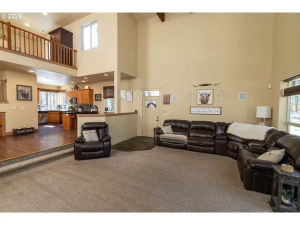 a living room with furniture a couch and a piano table