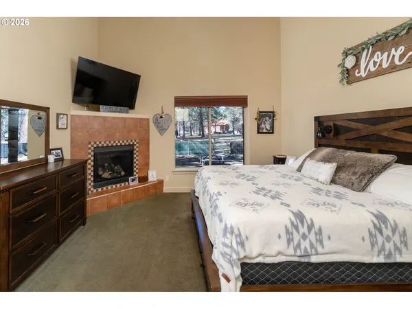a living room with a flat screen tv and a fireplace
