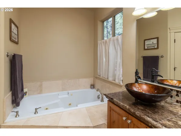 a spacious bathroom with a granite countertop sink and a mirror