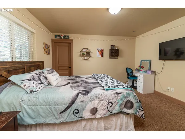 a bedroom with a bed and a television