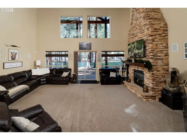 a living room with furniture a fireplace a flat screen tv and paintings on the wall