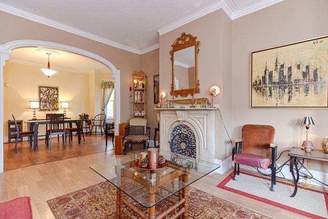 a living room with furniture a dining table and a fireplace