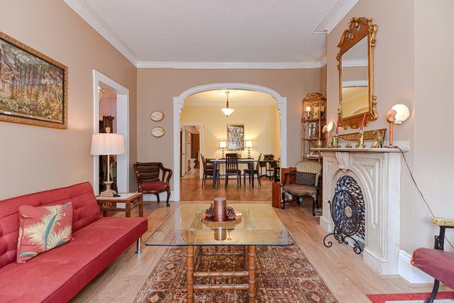 a living room with furniture a fireplace and a table