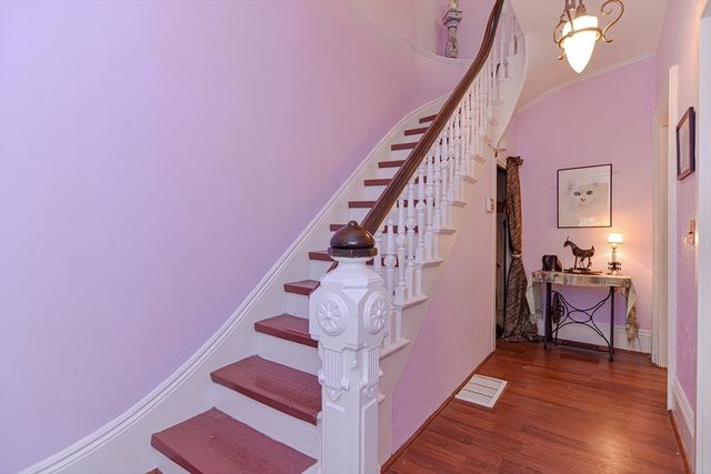 a view of entryway and hall with wooden floor