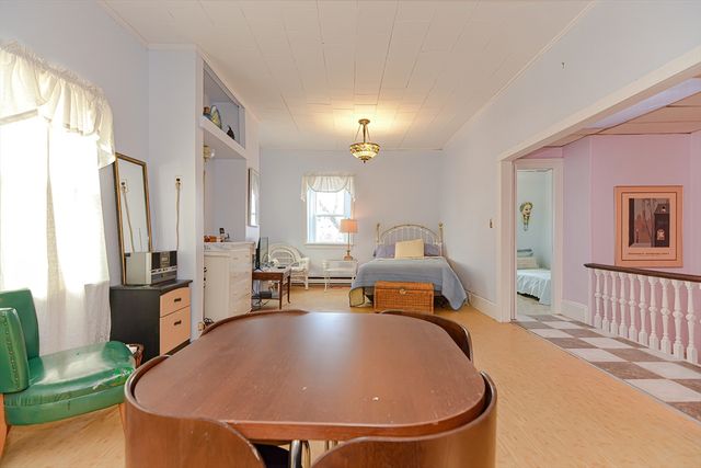 a living room with furniture a large window and wooden floor