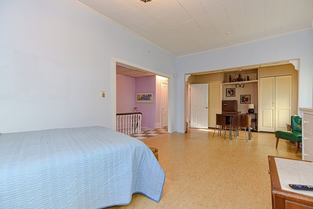 a spacious bedroom with a bed and a table in it