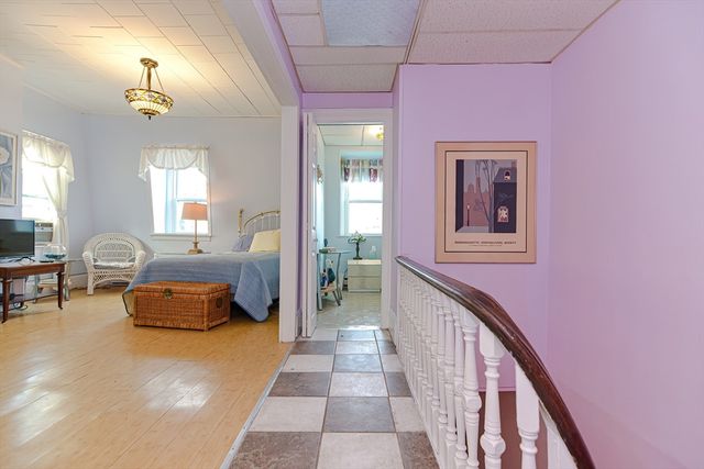 a hallway with a couch and chandelier