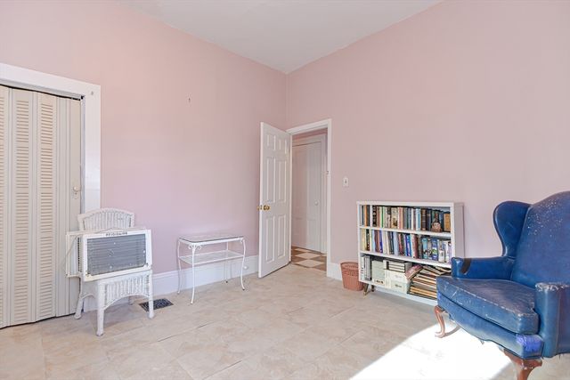 a living room with furniture and a book shelf