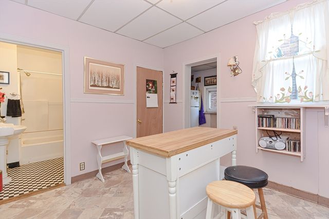a living room with a sink and next to a window