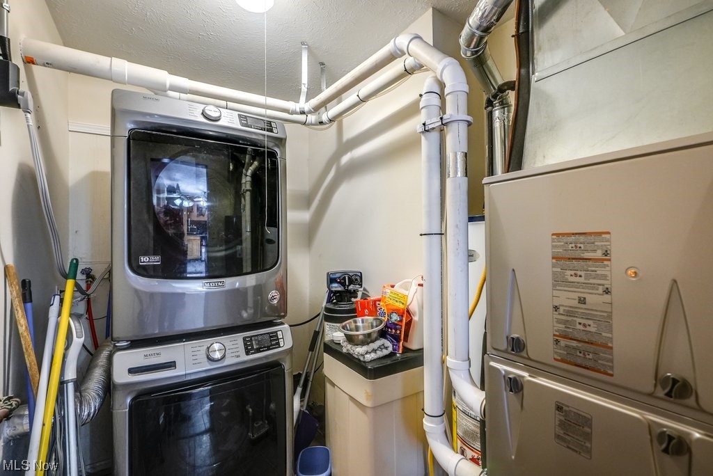 3658 Duffield Road Kent, OH 44240 - Photo 20 of 21 Laundry room featuring a textured ceiling and stacked washer and clothes dryer
