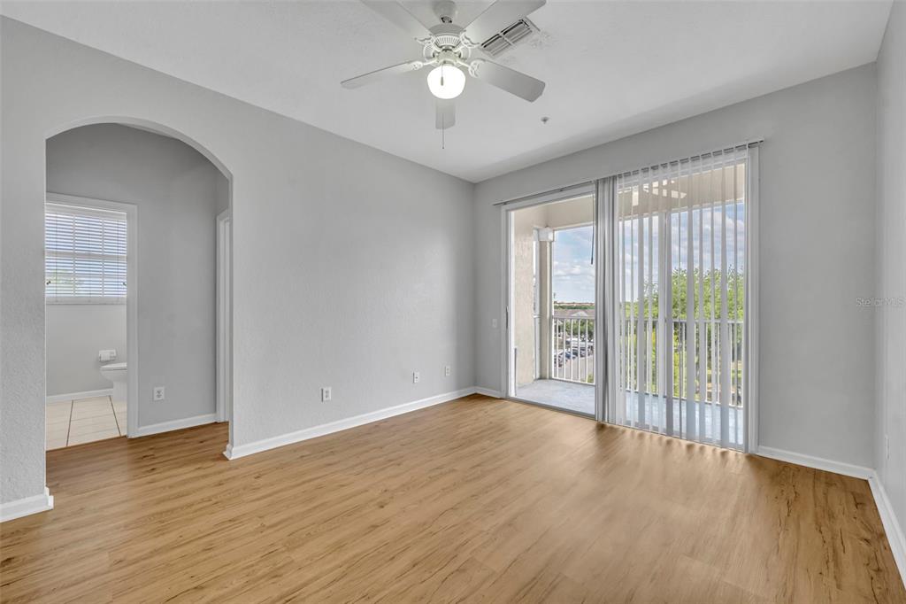 582 Brantley Terrace Way, Unit 304 Altamonte Springs, FL 32714 - Photo 14 of 30 a view of an empty room with wooden floor and a window