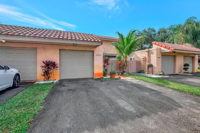 a view of a house with a yard and garage